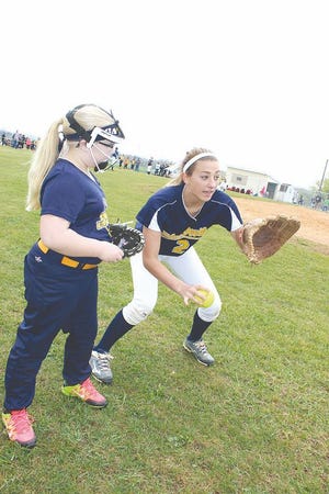 Greencastle-Antrim High School senior Liz Ward instructs Calleigh Hull, 9, Saturday during G-A Fastpitch opening day at the Shady Grove Ruritan grounds. For more photos of the action, turn to Page C-4.